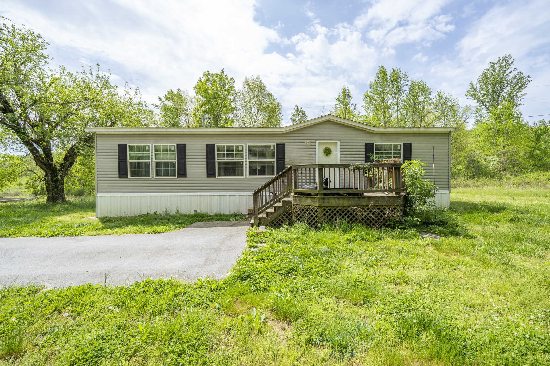 4242 Upper Factory Creek Road Waynesboro, TN 38485 - Photo 2 of 30 a front view of a house with a yard and potted plants