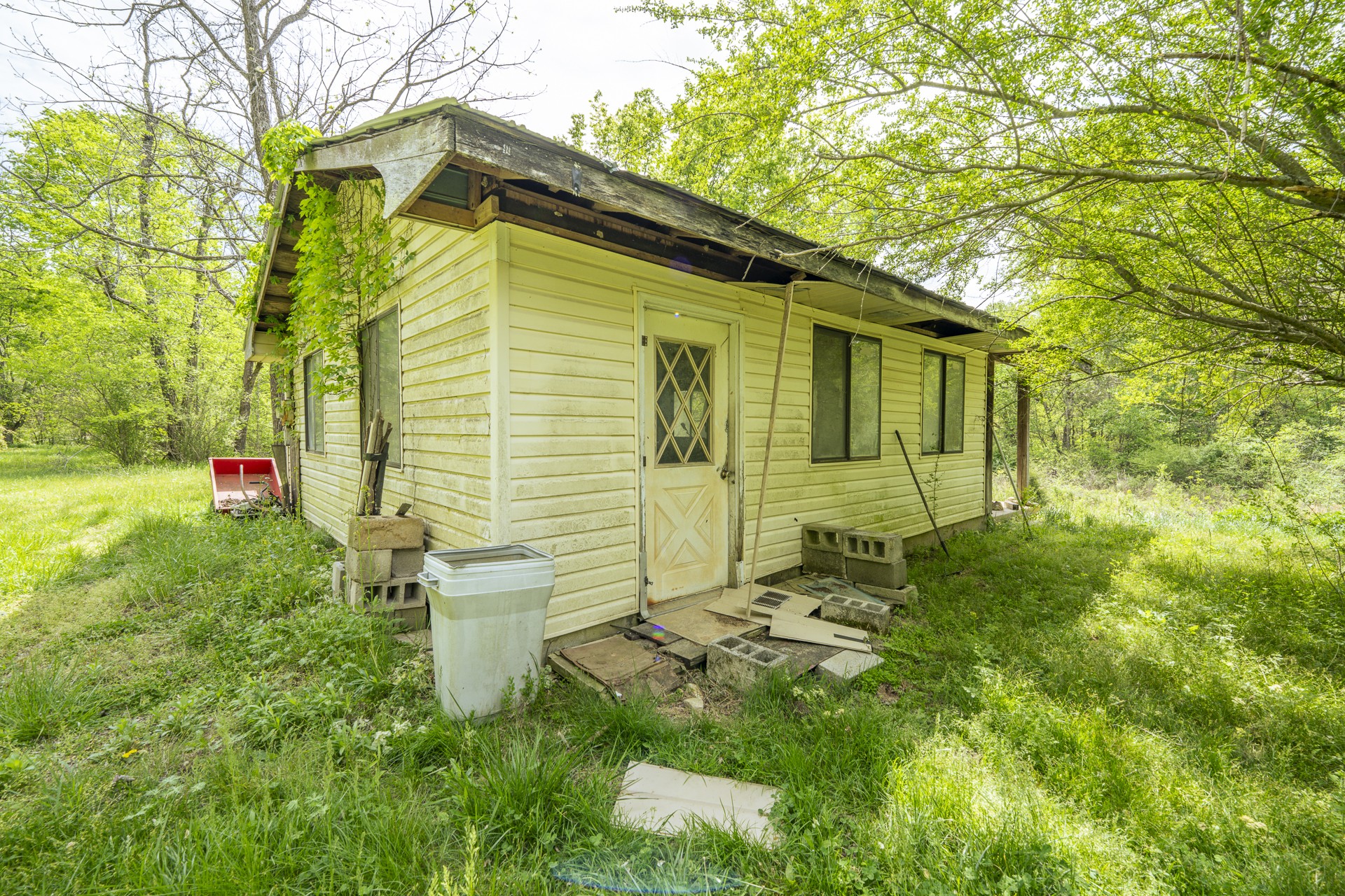 4242 Upper Factory Creek Road Waynesboro, TN 38485 - Photo 21 of 30 a view of a backyard with table and chairs and potted plants