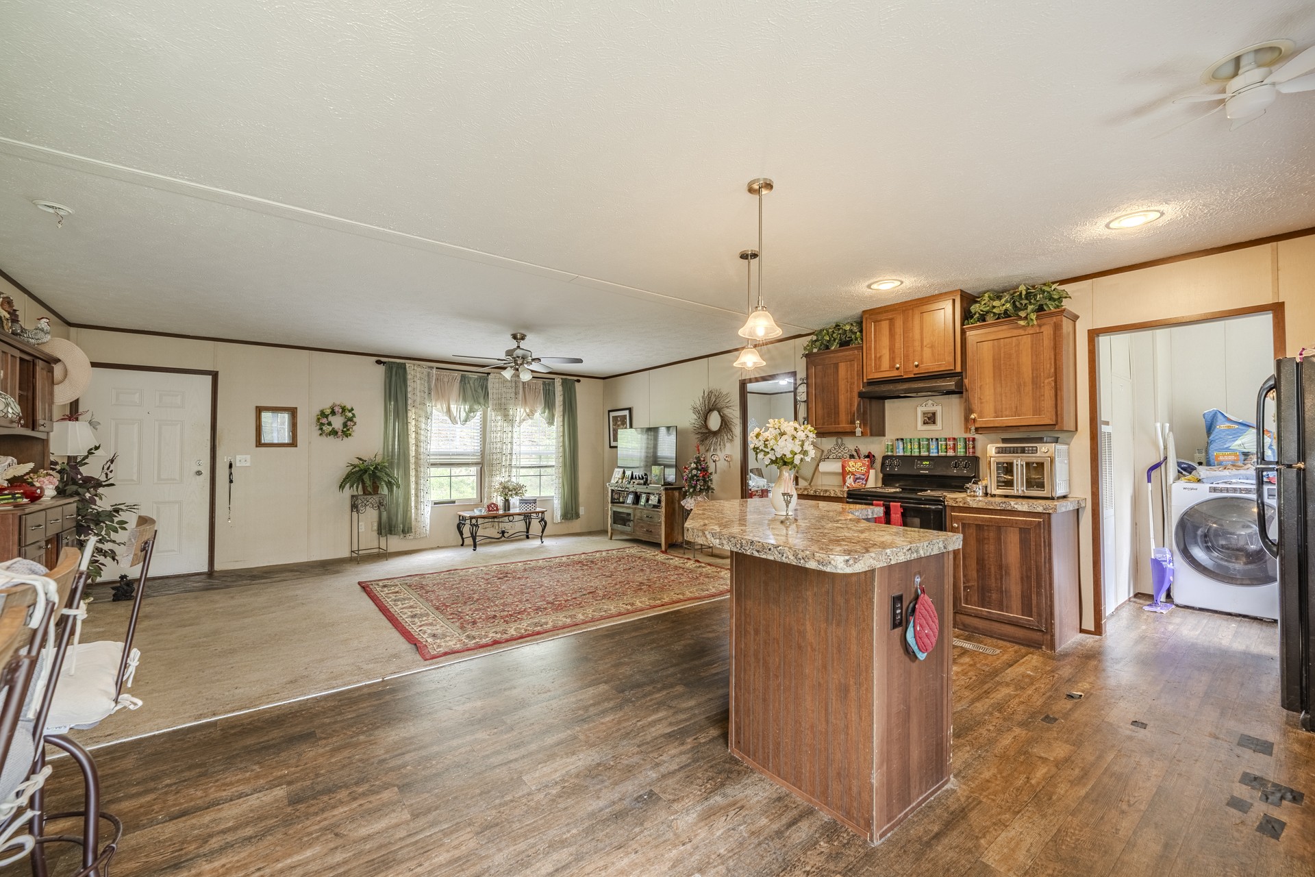 4242 Upper Factory Creek Road Waynesboro, TN 38485 - Photo 7 of 30 a open kitchen with stainless steel appliances granite countertop a stove oven and a refrigerator