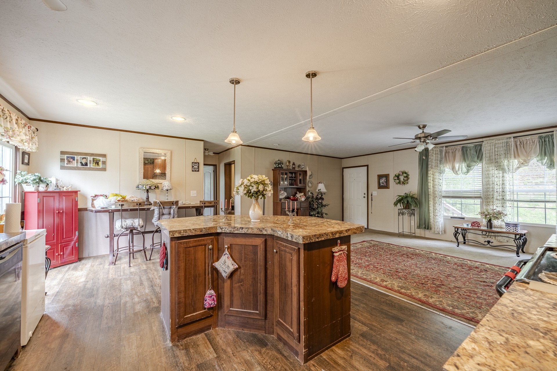 4242 Upper Factory Creek Road Waynesboro, TN 38485 - Photo 8 of 30 a view of a kitchen with kitchen island stainless steel appliances a sink and living room view