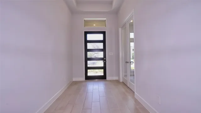 a view of a room with wooden floor