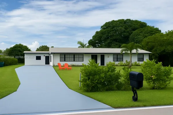 a front view of house with yard and green space