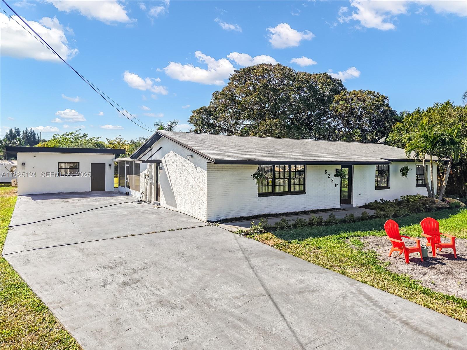 6231 Southwest 188th Avenue Southwest Ranches, FL 33332 - Photo 11 of 40 a front view of a house with a yard and garage