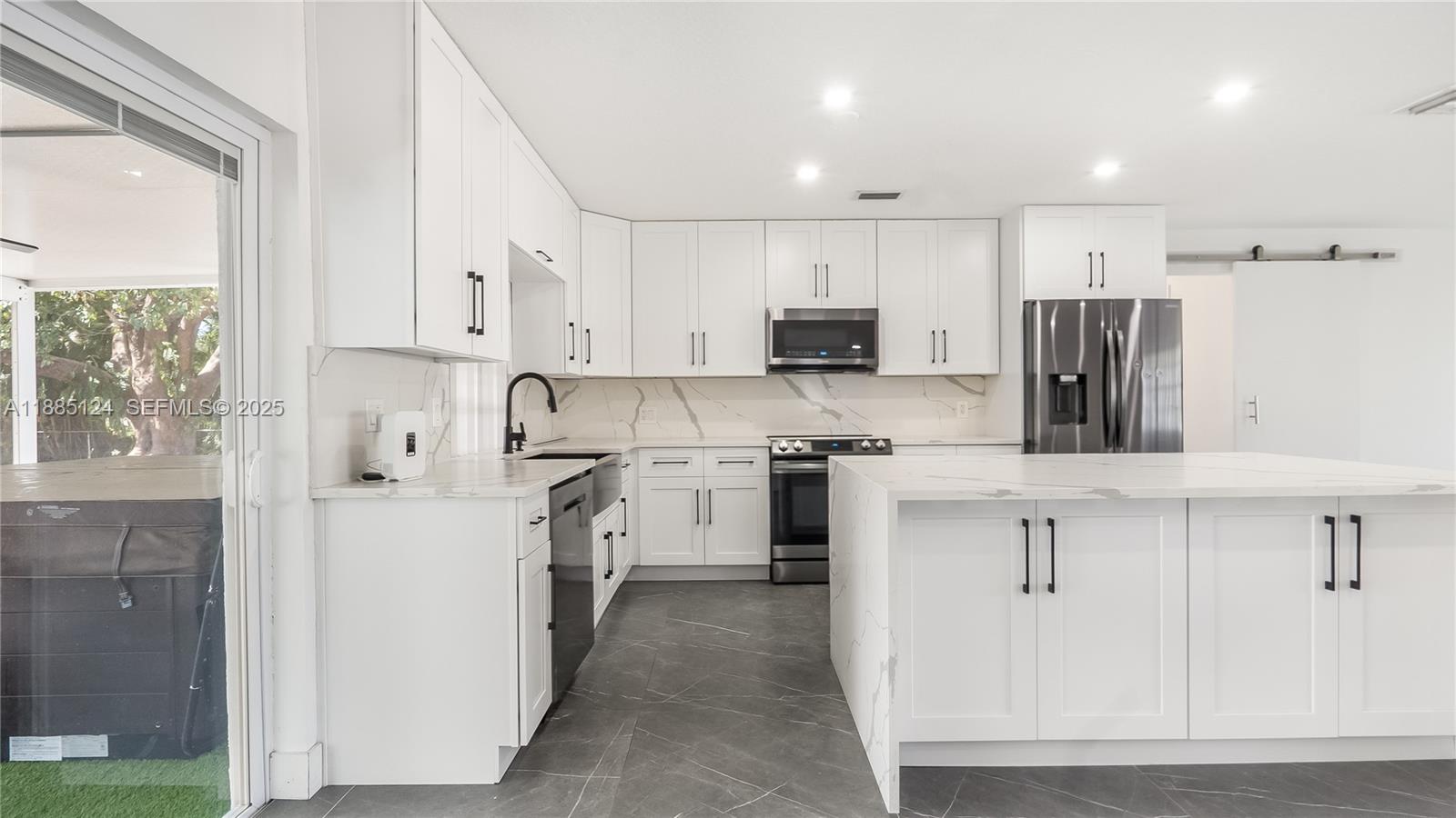 6231 Southwest 188th Avenue Southwest Ranches, FL 33332 - Photo 16 of 40 a kitchen with white cabinets and stainless steel appliances