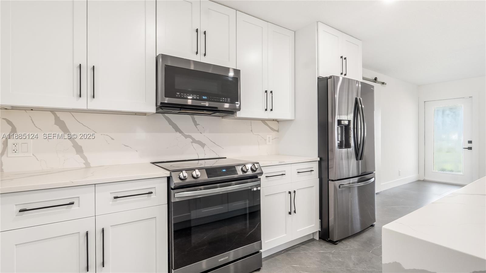 6231 Southwest 188th Avenue Southwest Ranches, FL 33332 - Photo 17 of 40 a kitchen with white cabinets and stainless steel appliances