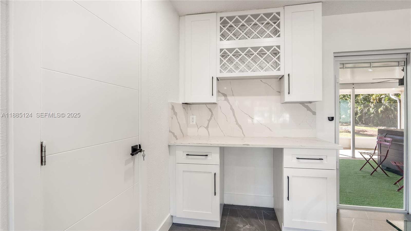 6231 Southwest 188th Avenue Southwest Ranches, FL 33332 - Photo 19 of 40 a close view of a refrigerator in kitchen with white cabinets and wooden floor