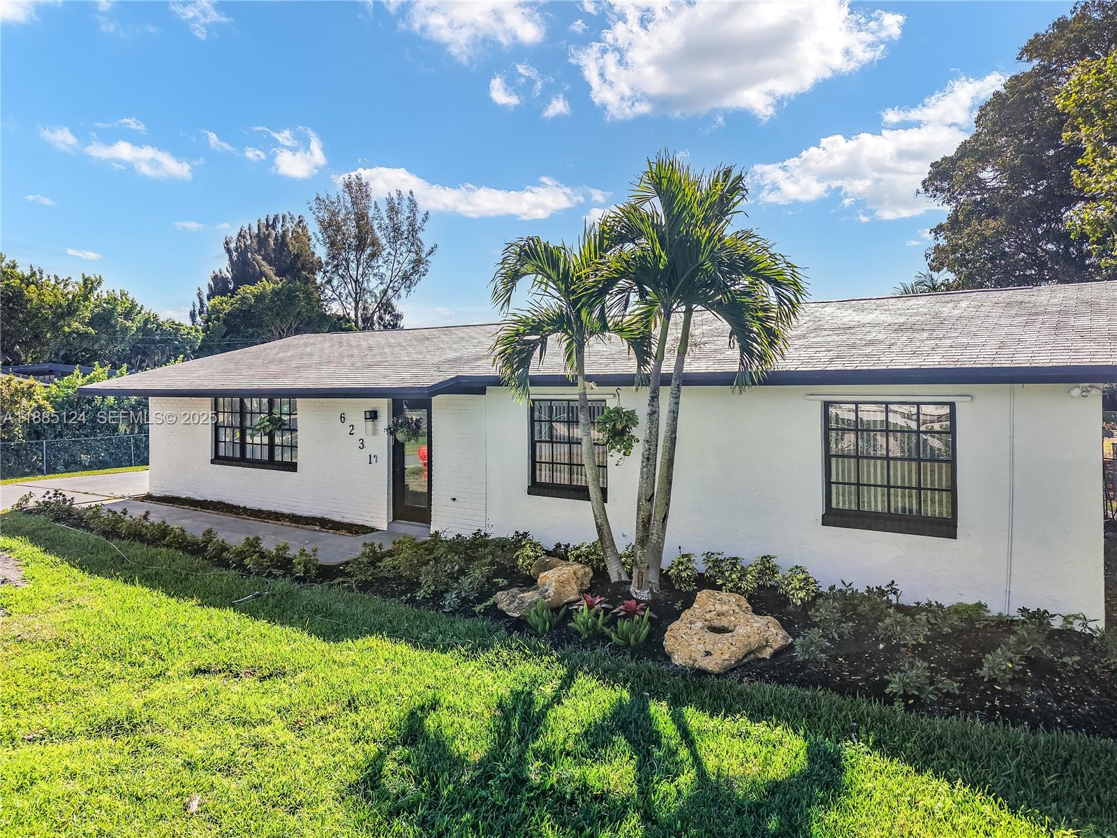 6231 Southwest 188th Avenue Southwest Ranches, FL 33332 - Photo 3 of 40 a front view of a house with a yard