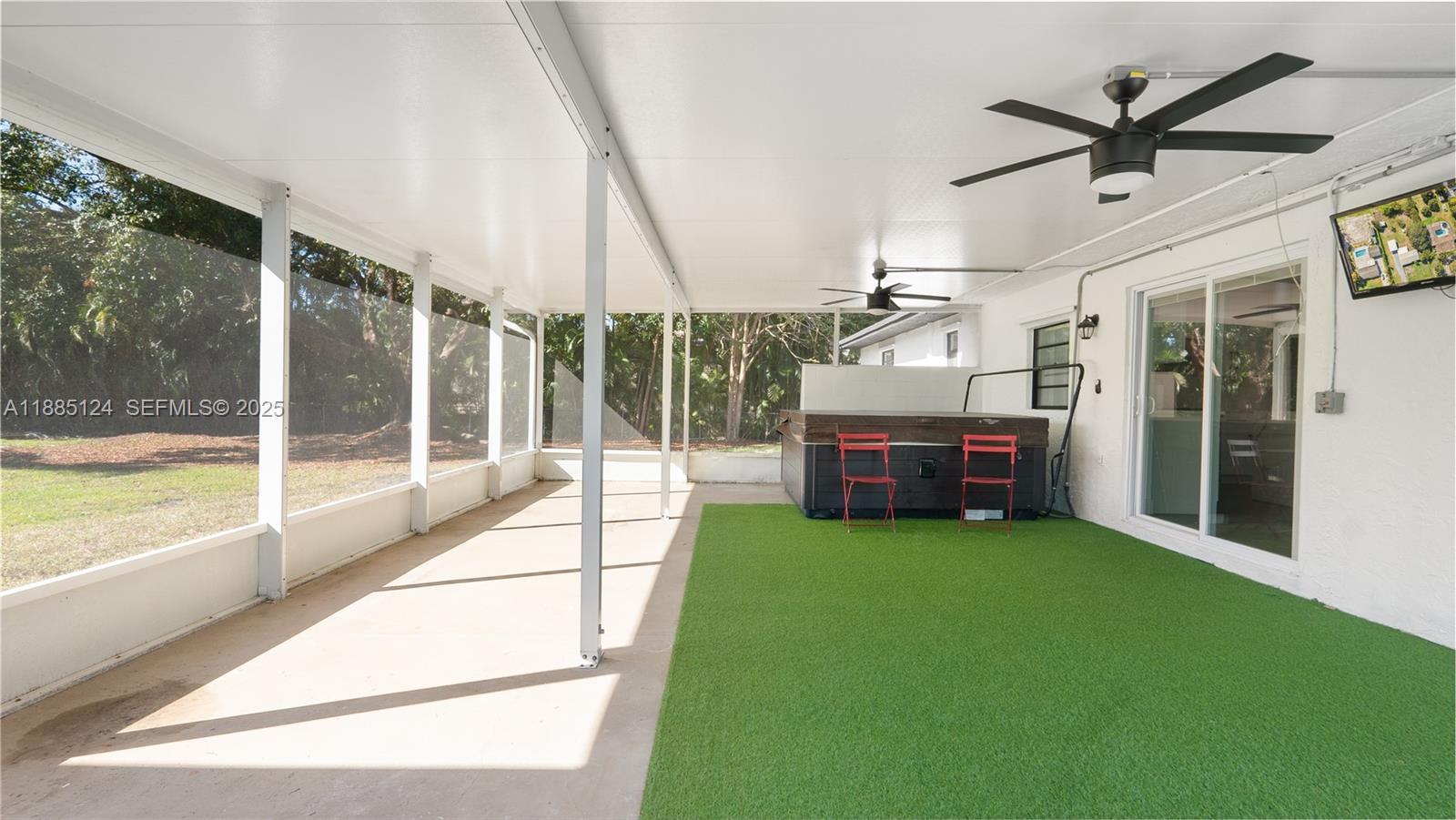 6231 Southwest 188th Avenue Southwest Ranches, FL 33332 - Photo 34 of 40 a living room with a floor to ceiling window and a ceiling fan