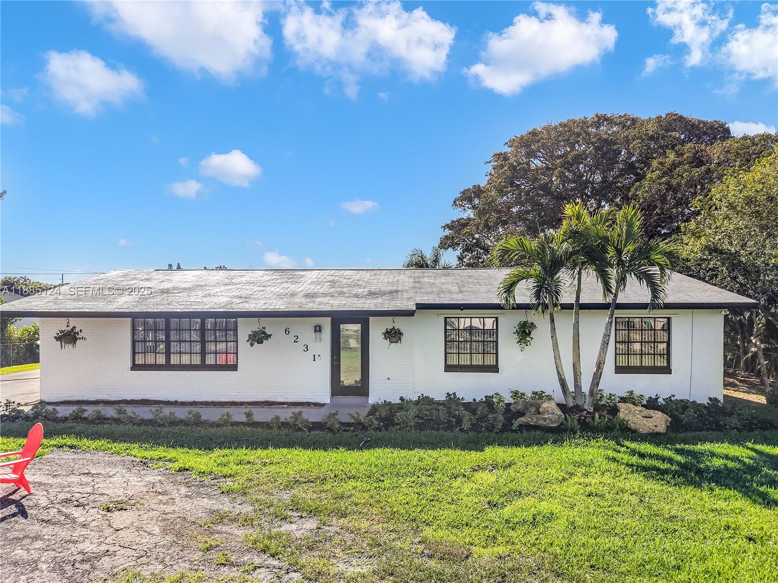 6231 Southwest 188th Avenue Southwest Ranches, FL 33332 - Photo 7 of 40 a front view of a house with garden