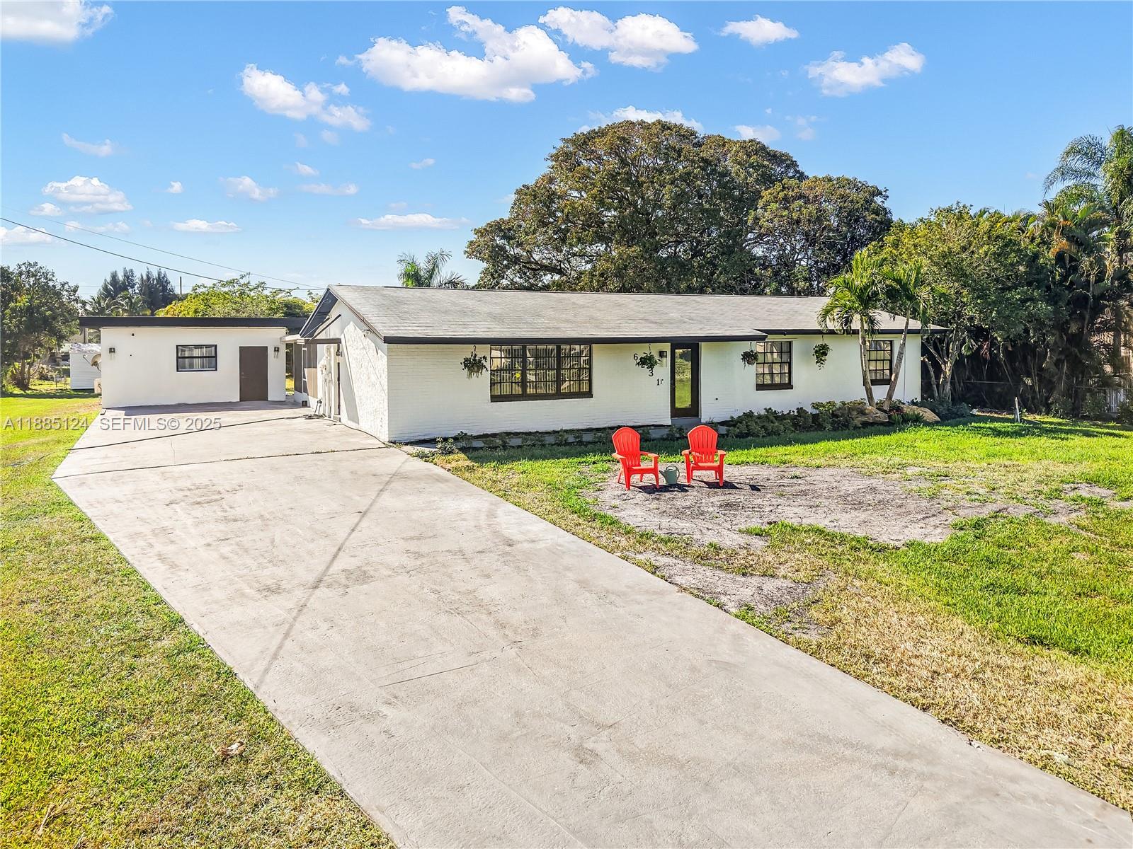 6231 Southwest 188th Avenue Southwest Ranches, FL 33332 - Photo 8 of 40 a front view of house with yard outdoor seating and green space