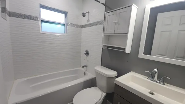 a bathroom with a sink toilet and shower