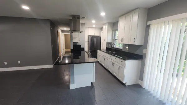 a kitchen with stainless steel appliances a refrigerator sink and cabinets