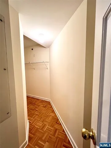 a view of a room with wooden floor