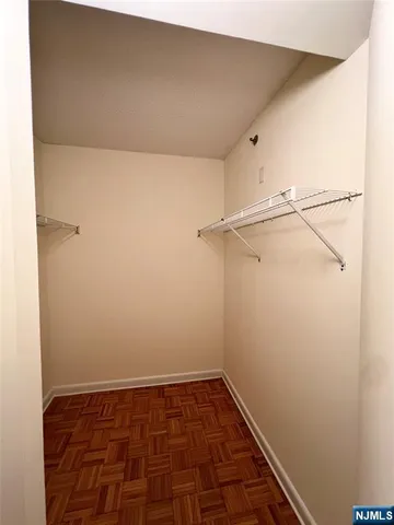 a bathroom with a tub sink vanity granite and mirror