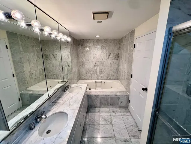 a view of a bathroom with bathtub and shower