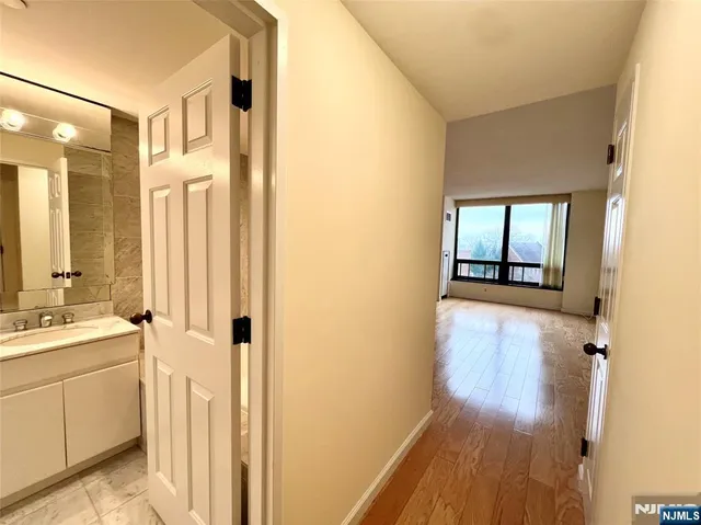 a bathroom with a glass door shower a sink and a bathtub