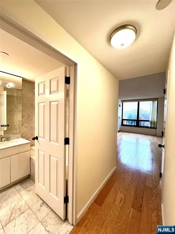 a view of a kitchen with wooden floor and electronic appliances