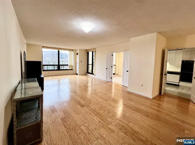 a kitchen with stainless steel appliances kitchen island granite countertop a refrigerator and a sink