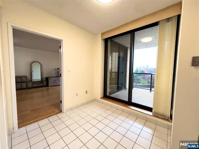 a large white room with kitchen view
