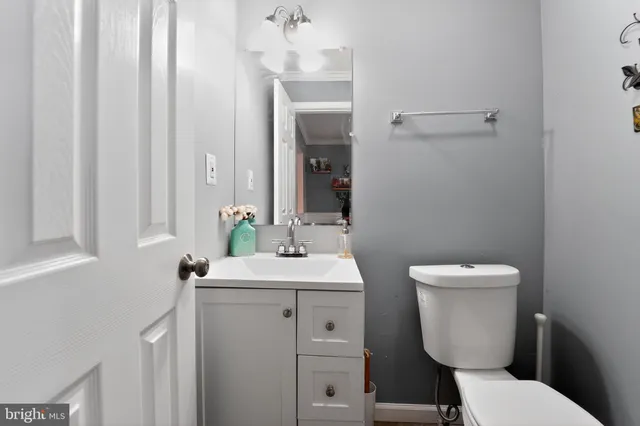a bathroom with a toilet a sink and mirror
