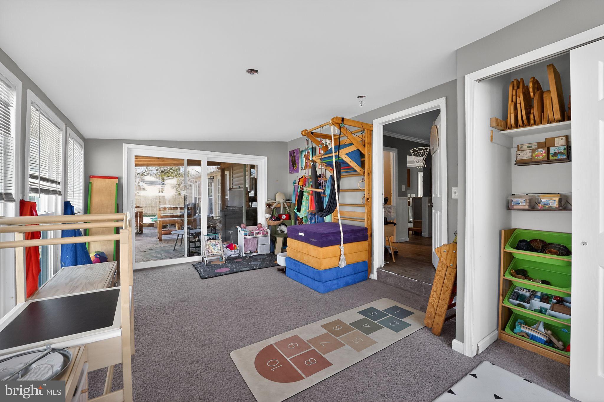 7819 Bertha Road Pasadena, MD 21122 - Photo 22 of 31 a living room with furniture and a floor to ceiling window