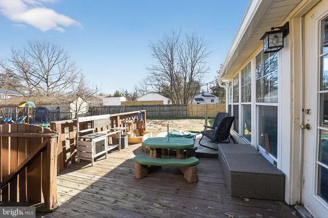 a view of a balcony with chairs and wooden floor