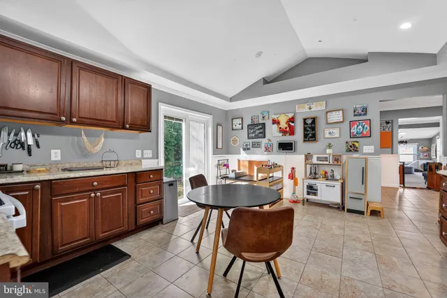 a kitchen with stainless steel appliances granite countertop a sink and cabinets