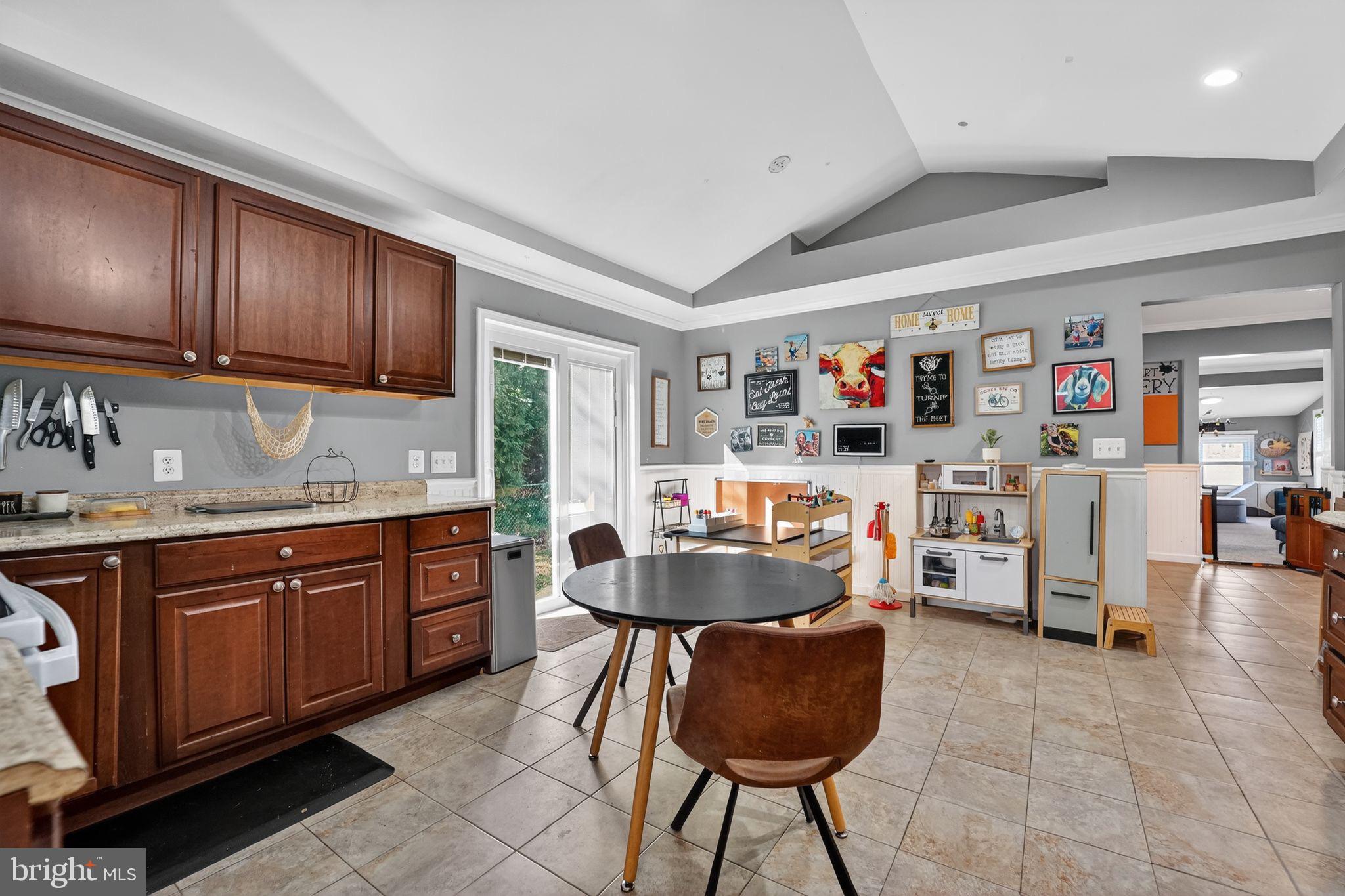 7819 Bertha Road Pasadena, MD 21122 - Photo 7 of 31 a kitchen with stainless steel appliances granite countertop a sink and cabinets