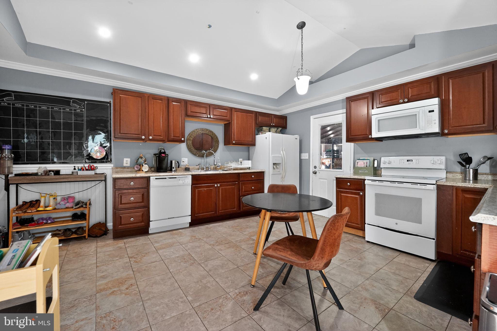 7819 Bertha Road Pasadena, MD 21122 - Photo 9 of 31 a kitchen with a sink stainless steel appliances and cabinets