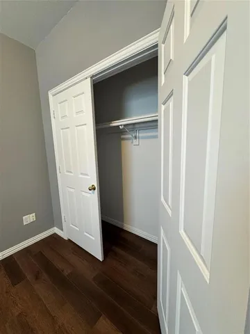 a view of walk in closet with wooden floor