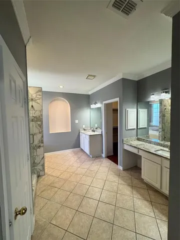 a spacious bathroom with a mirror a bathtub and a shower