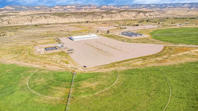 a view of a swimming pool with a table and chairs in patio