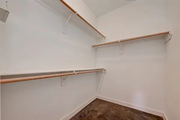 an empty room with wooden floor fireplace and cabinet