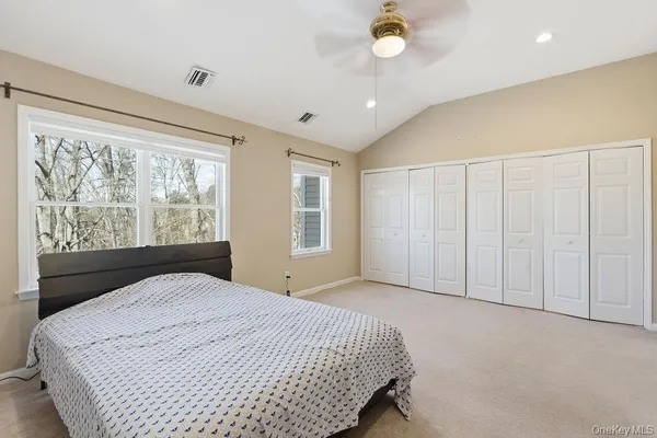 a bedroom with a large bed and a large window