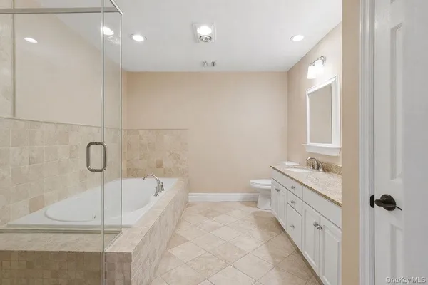 a bathroom with a double vanity sink toilet and shower