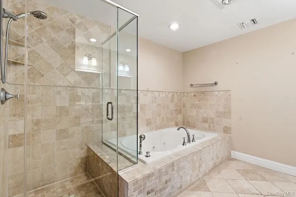 a bathroom with a bathtub and shower
