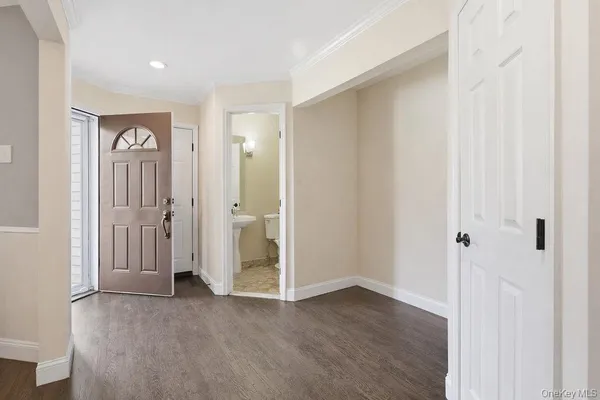 an empty room with windows wooden floor and closet area