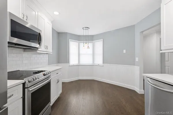 a kitchen with a stove and a microwave