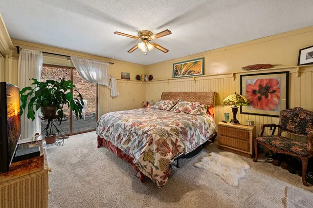 a view of a house with yard and sitting area