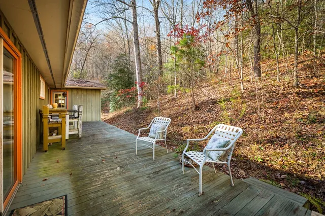 a backyard of a house with a yard and outdoor seating