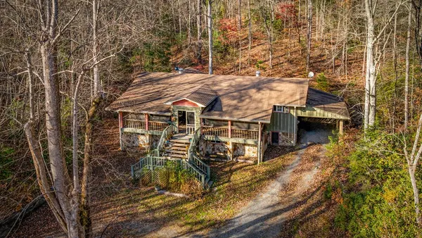 a living room with lots of furniture and a large window