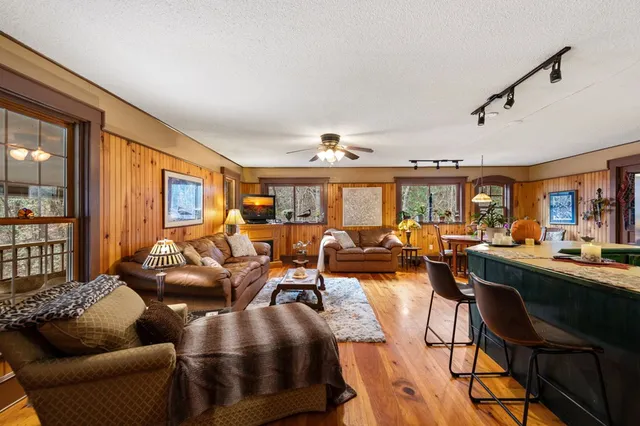 a living room with furniture fireplace and a flat screen tv