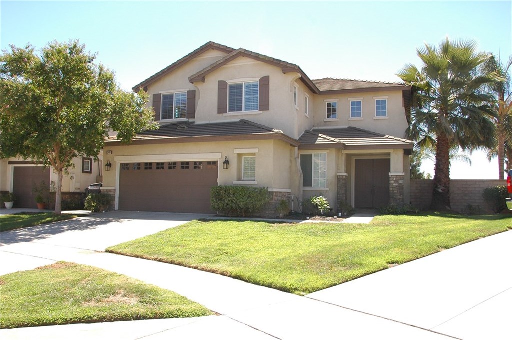 12401 Harwick Drive Rancho Cucamonga, CA 91739 - Photo 1 of 1 a front view of a house with a yard and garage