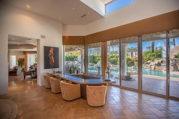 a living room with furniture and large windows