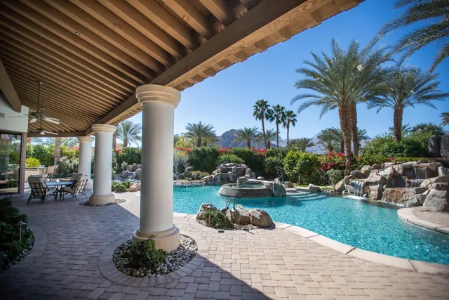 a view of a backyard with plants and outdoor seating