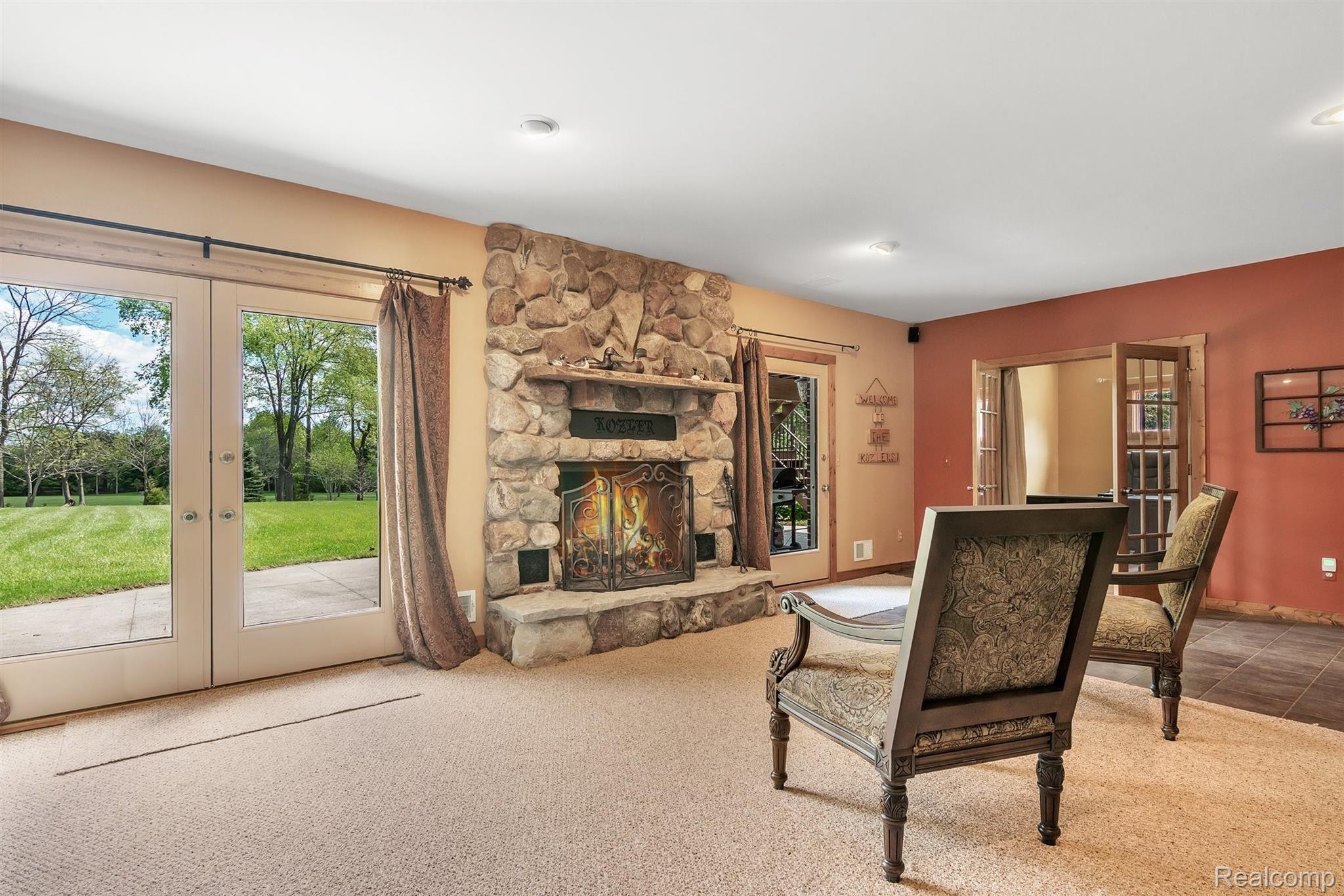 5786 South Weed Road Plymouth, MI 48170 - Photo 39 of 55 Lower level fireplace and view of property