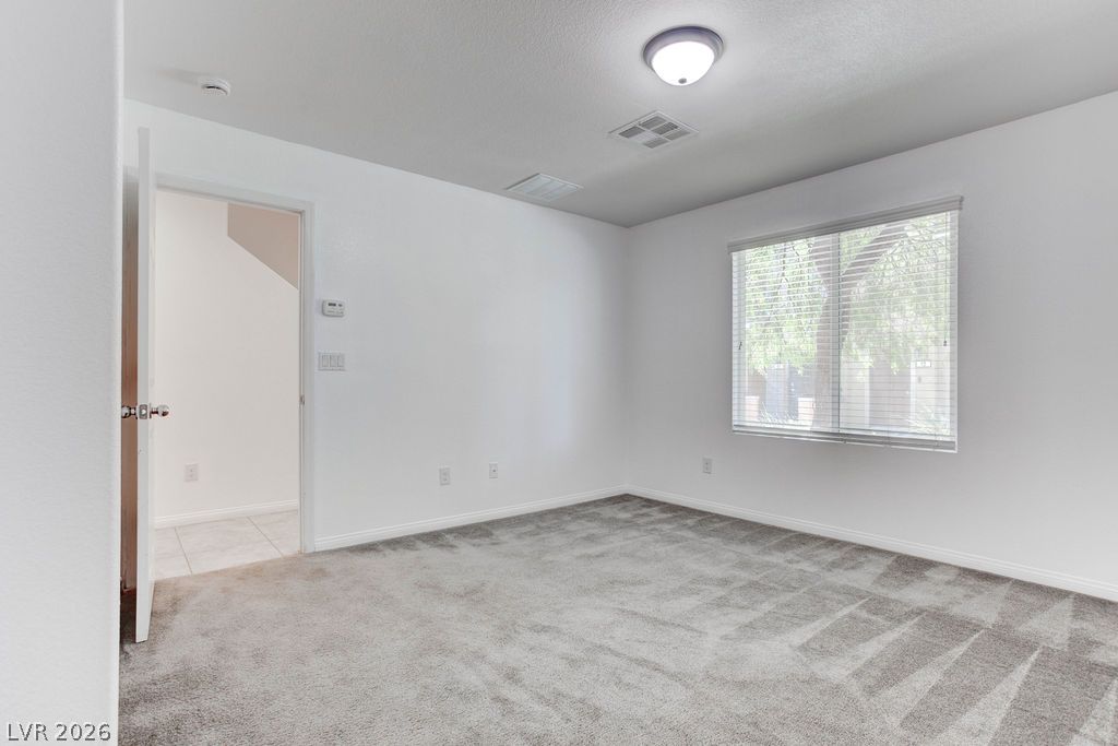 4650 Ranch House Road, Unit 47 North Las Vegas, NV 89031 - Photo 36 of 43 Well-lit room with ample space for personalization and plush carpet flooring.