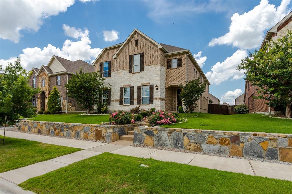 6333 Hall Road Frisco, TX 75034 - Photo 4 of 38 Two-story residence featuring a brick and stone facade with decorative shutters