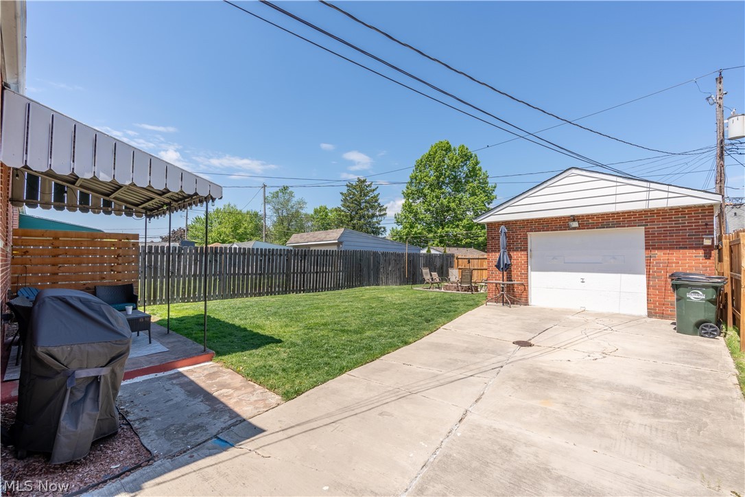 8320 Ackley Road Parma, OH 44129 - Photo 28 of 36 View of yard with an outdoor structure and a garage