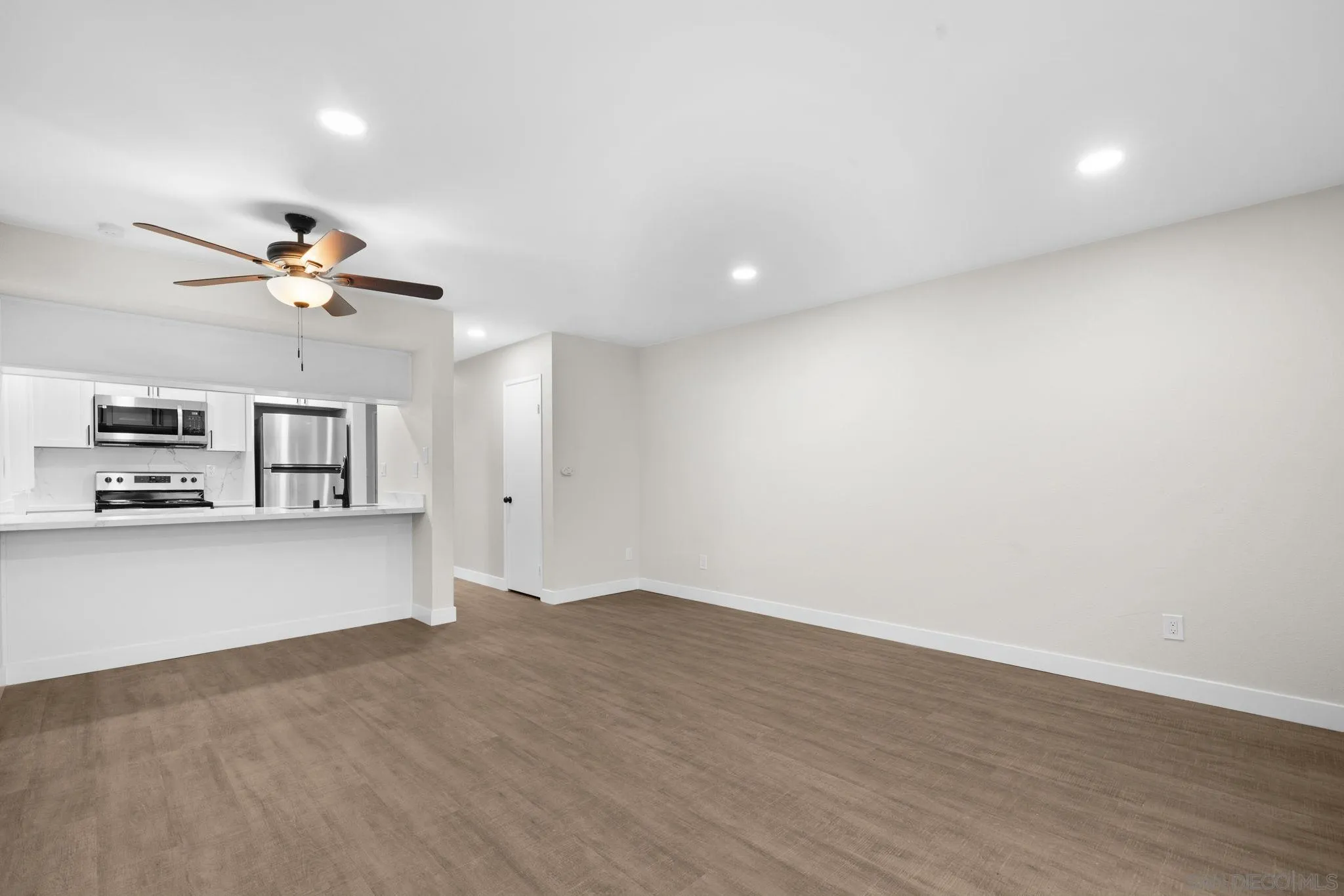 748 North 3rd Street, Unit Q El Cajon, CA 92021 - Photo 6 of 16 wooden floor in an empty room with a window